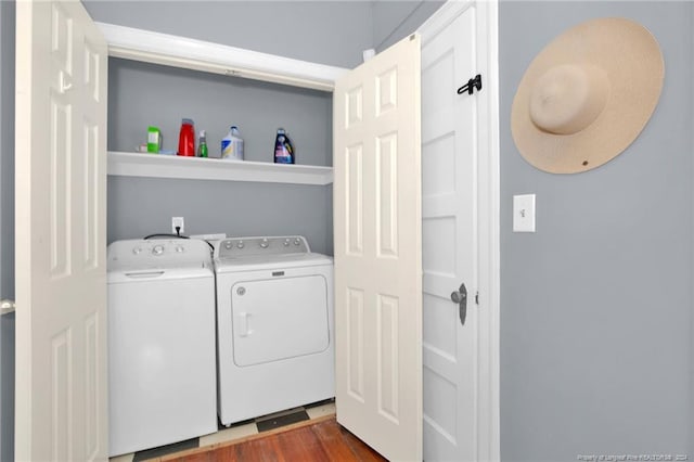 washroom with hardwood / wood-style flooring and independent washer and dryer