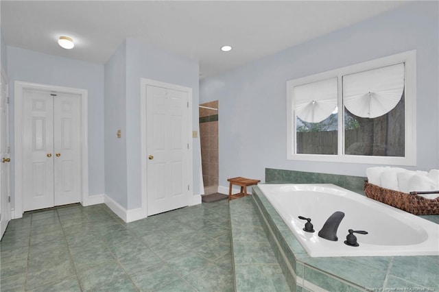 bathroom featuring separate shower and tub and tile patterned floors