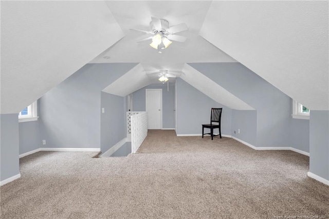 additional living space featuring ceiling fan, plenty of natural light, and carpet flooring