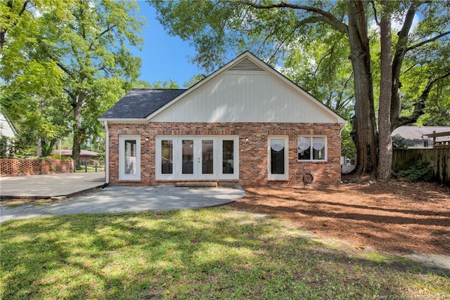 rear view of property with a patio area, french doors, and a yard