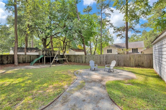 view of yard featuring a playground and a patio area