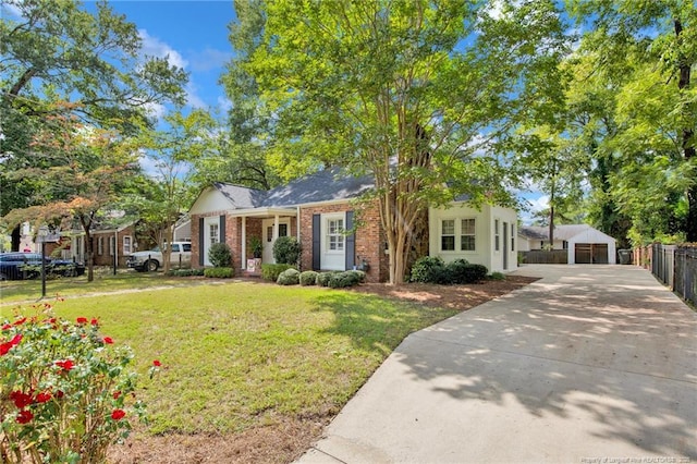507 Huske St, Fayetteville, NC 28305 - view of front facade featuring driveway, fence, an outdoor structure, a front yard, and brick siding