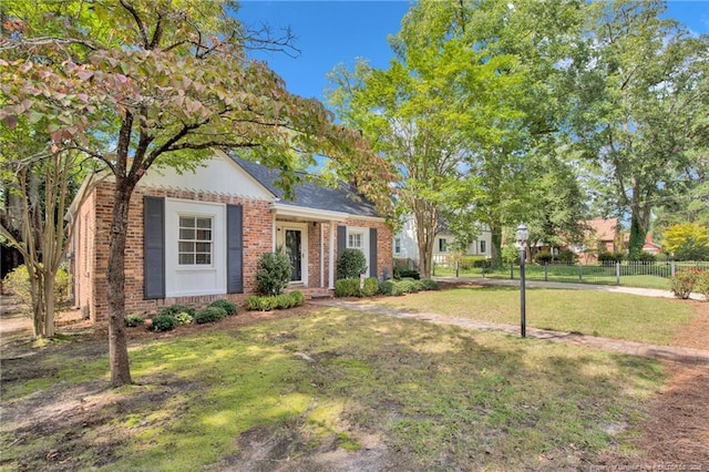 507 Huske St, Fayetteville, NC 28305 - view of front of house with brick siding, a front yard, and fence