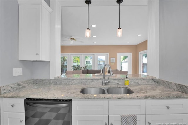 507 Huske St, Fayetteville, NC 28305 - kitchen with light stone countertops, white cabinetry, ceiling fan, a sink, and dishwasher