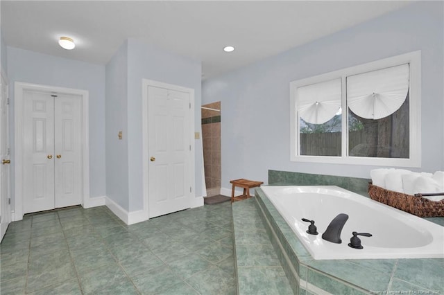 507 Huske St, Fayetteville, NC 28305 - bathroom with a bath, tile patterned flooring, baseboards, and a closet