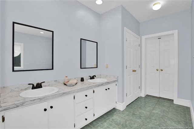 507 Huske St, Fayetteville, NC 28305 - full bathroom featuring double vanity, baseboards, a closet, and a sink