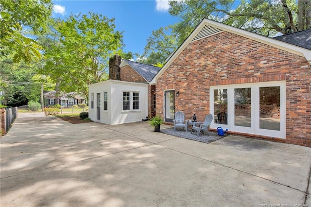 507 Huske St, Fayetteville, NC 28305 - back of property featuring brick siding, a patio area, french doors, and a chimney