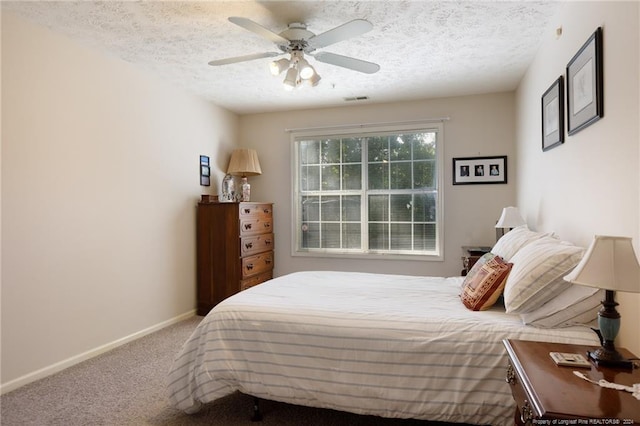 carpeted bedroom with a textured ceiling and ceiling fan