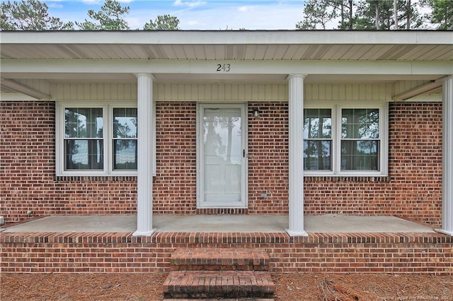 doorway to property featuring covered porch