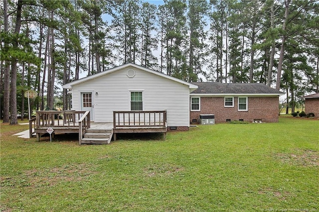 back of property featuring a deck, a yard, and central air condition unit