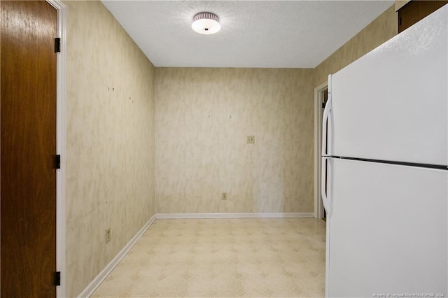 kitchen featuring a textured ceiling and white refrigerator