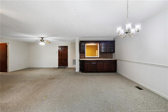 unfurnished living room featuring ceiling fan with notable chandelier and light carpet