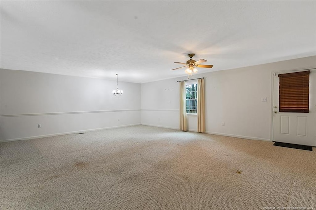 unfurnished room with carpet floors and ceiling fan with notable chandelier