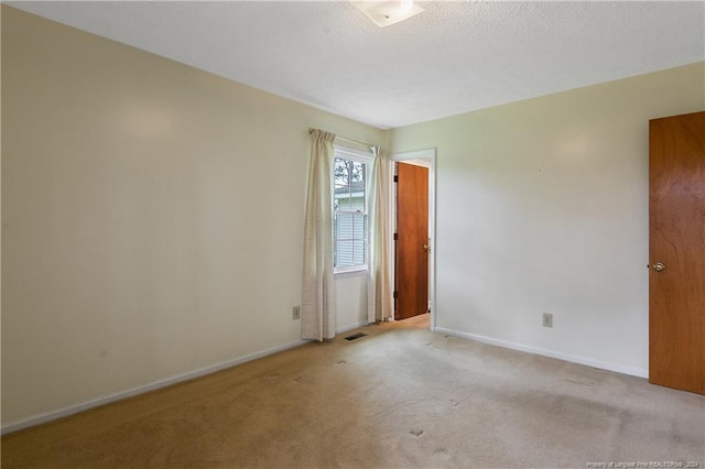 empty room with light colored carpet