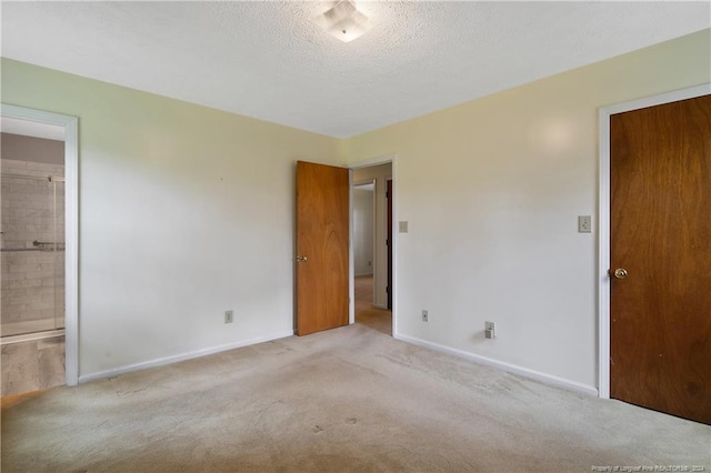 carpeted spare room with a textured ceiling