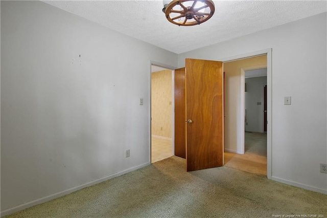 unfurnished bedroom with a textured ceiling and carpet flooring