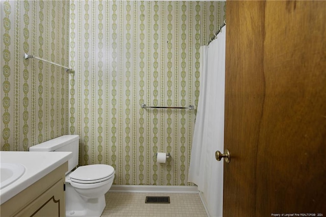 bathroom featuring vanity, toilet, and tile patterned floors