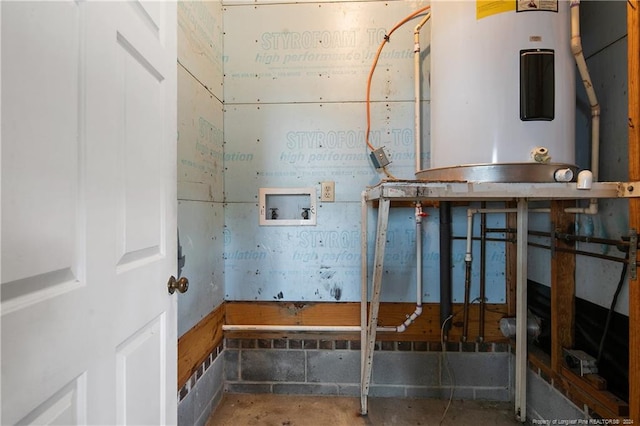 interior space featuring concrete flooring and electric water heater