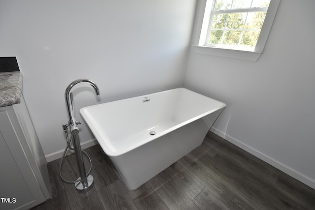 bathroom with a bathing tub and wood-type flooring