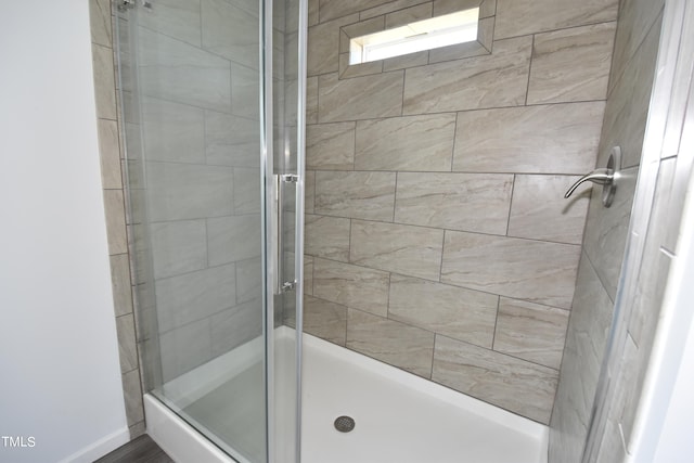 bathroom featuring a shower with shower door