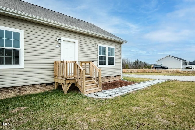 doorway to property featuring a yard