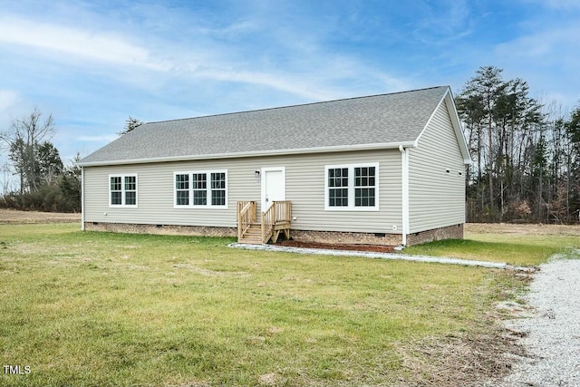 rear view of house featuring a yard