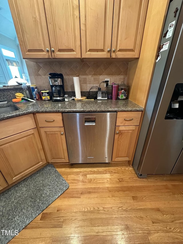 kitchen featuring backsplash, light hardwood / wood-style floors, and stainless steel appliances