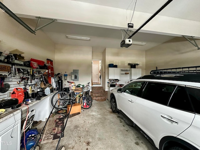 garage with electric panel and a garage door opener