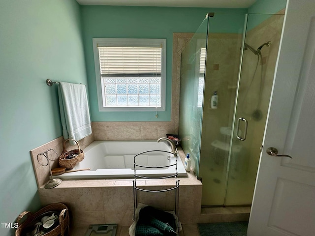 bathroom with independent shower and bath and tile patterned flooring