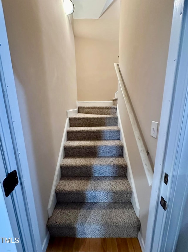 stairs featuring wood-type flooring