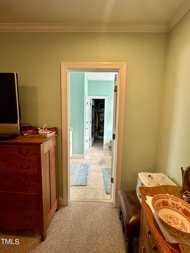 hallway featuring ornamental molding and light carpet