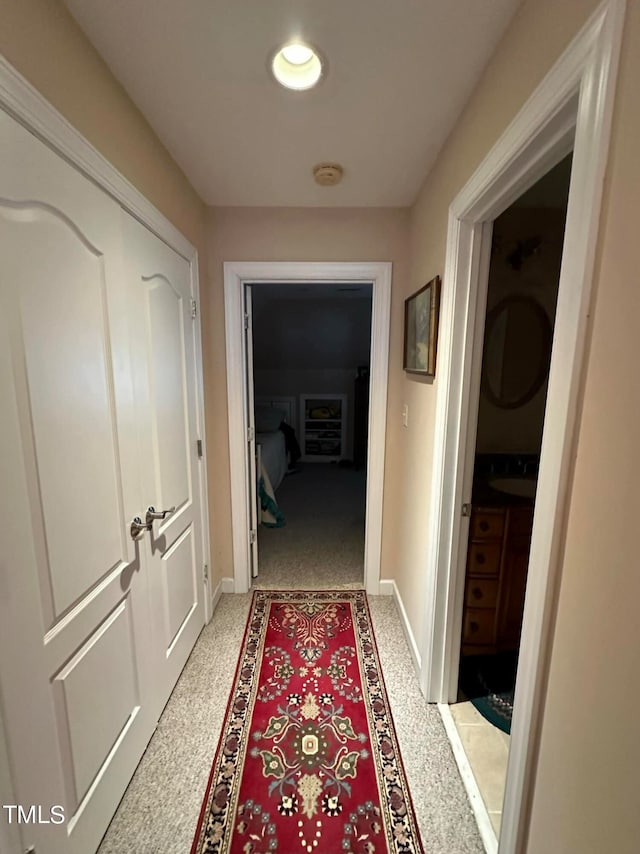 corridor featuring carpet floors and sink