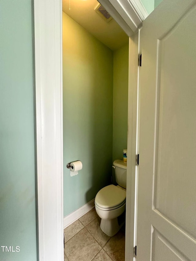 bathroom featuring tile patterned flooring and toilet