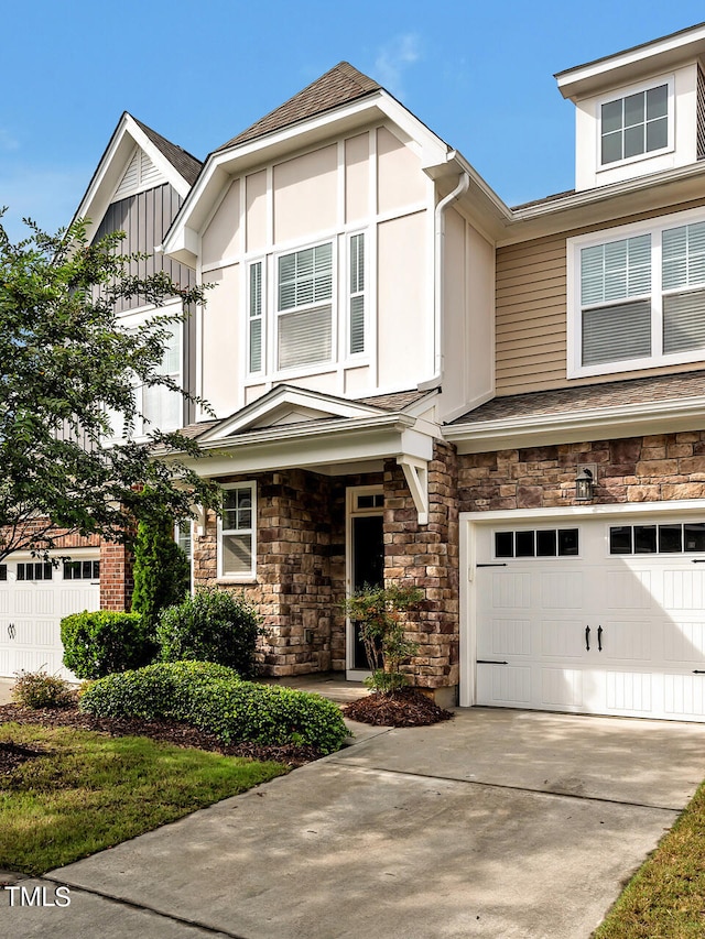 1215 Alston Forest Dr, Cary, NC 27519 - view of front of house with a garage, driveway, stone siding, and roof with shingles