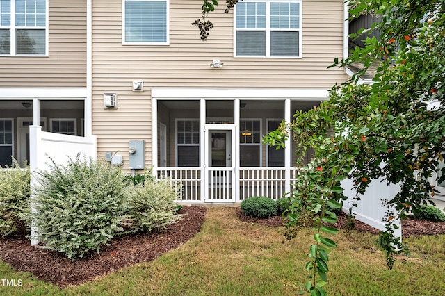 exterior space with a yard and a sunroom