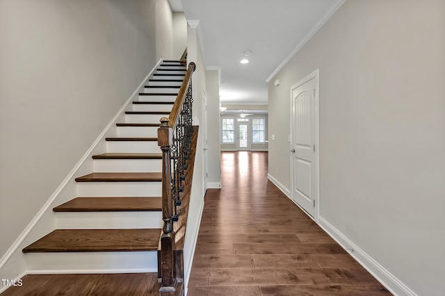 staircase with crown molding, hardwood / wood-style floors, and ceiling fan