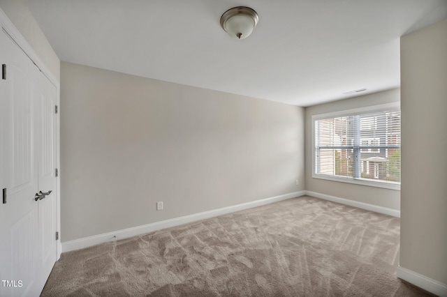 empty room featuring light carpet