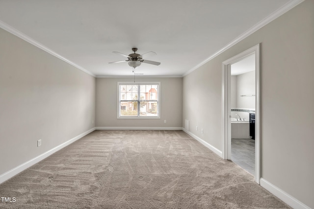 unfurnished room featuring ornamental molding, light carpet, and ceiling fan