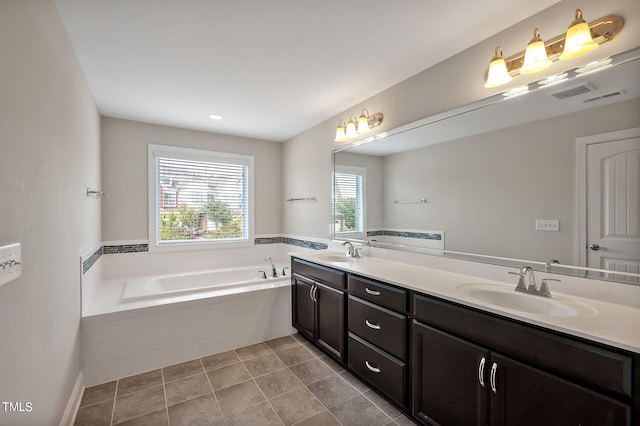 bathroom featuring vanity, tile patterned flooring, and a relaxing tiled tub