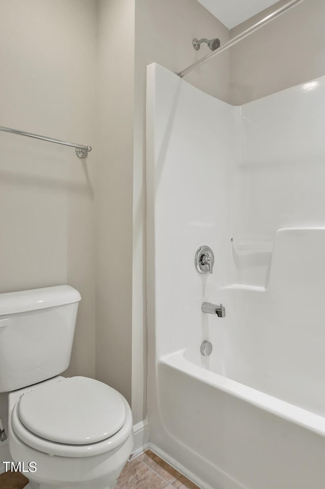 bathroom featuring toilet and bathing tub / shower combination