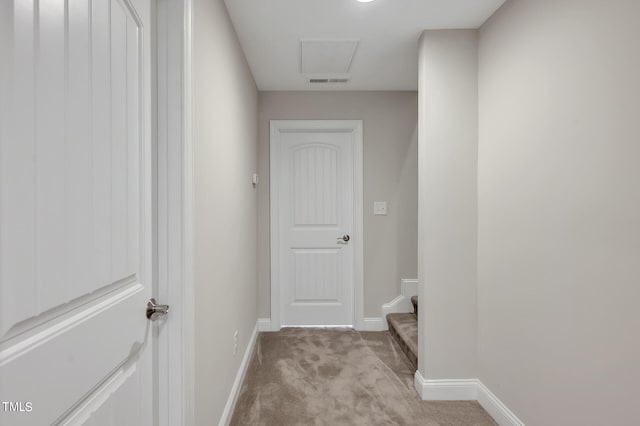 hallway featuring light colored carpet