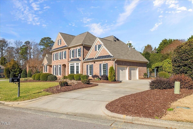 view of front of house featuring a front lawn and a garage