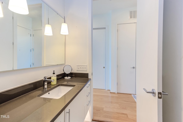 bathroom with vanity and hardwood / wood-style floors