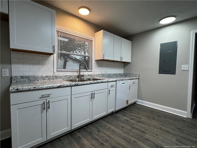 kitchen featuring white cabinetry, dishwasher, sink, electric panel, and light stone countertops