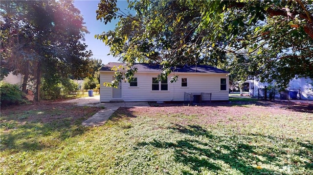 rear view of house with a lawn