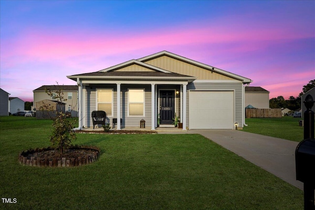 view of front of house featuring a yard and a garage