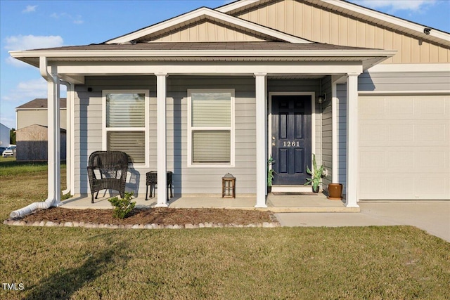 view of front facade with a front lawn, a porch, and a garage