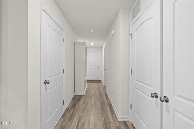 hall with hardwood / wood-style flooring