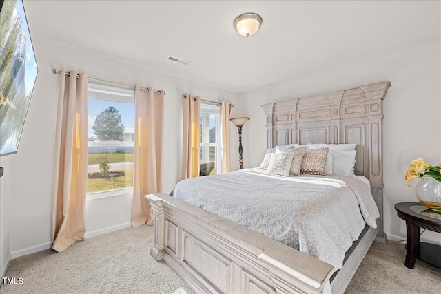 bedroom with light colored carpet