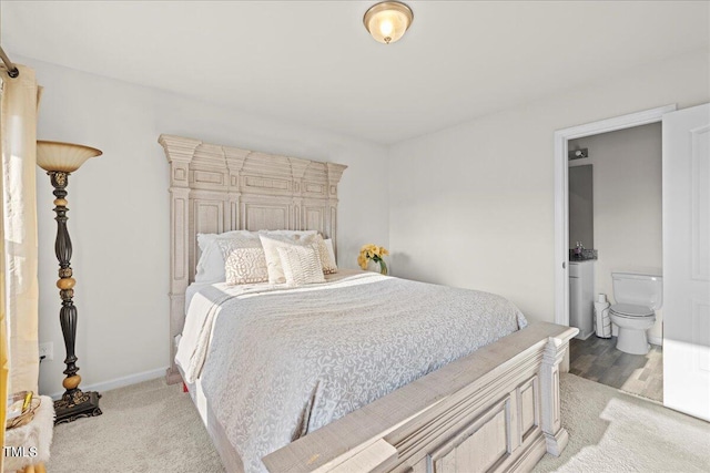 carpeted bedroom featuring ensuite bathroom